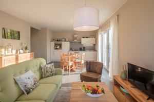 a living room with a couch and a table at WaldResort in Weberstedt