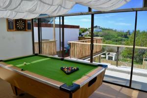 a pool table in a room with a view at The Green Palm Cottage in Plettenberg Bay