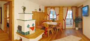 a living room with a table and a fireplace at Ramsbergerhof in Ramsau am Dachstein