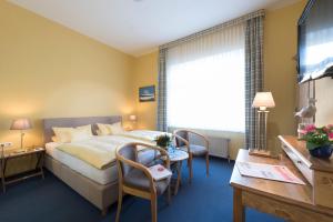 Ein Bett oder Betten in einem Zimmer der Unterkunft Atlantic Hotel Garni