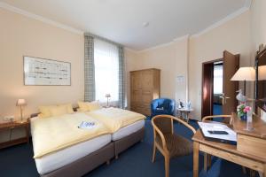 Ein Bett oder Betten in einem Zimmer der Unterkunft Atlantic Hotel Garni
