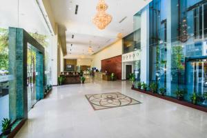 a lobby of a building with a flower on the floor at Mondial Hotel Hue in Hue +107 photos