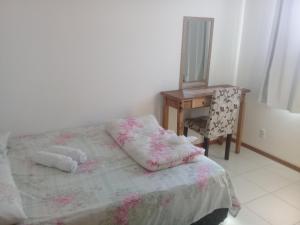 a bedroom with a bed and a desk and a chair at Apartamento Central in Penha +56 photos
