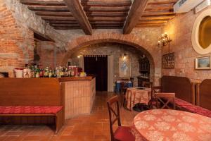 a restaurant with a bar with tables and chairs at Ca' De' Principi - Residenza D'epoca in Piegaro