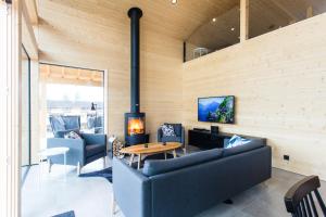a living room with two couches and a fireplace at Eerikkilä Sport & Outdoor Resort in Tammela