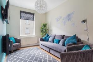 a living room with a couch and two chairs at Bishop's Rest in Bishop Auckland