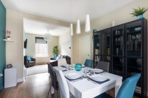 a dining room and living room with a white table and chairs at Bishop's Rest in Bishop Auckland