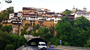 a van driving down a road in front of a bridge at Trendy Inn in Veliko Tŭrnovo