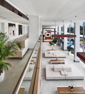 an open lobby with white furniture and large windows at Eureka Palace Hotel Spa Resort in Cassibile