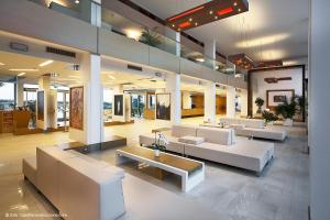 a lobby with couches and tables in a building at Eureka Palace Hotel Spa Resort in Cassibile