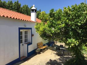 a white house with a lighthouse on top of it at Quinta Boavista in Cercal