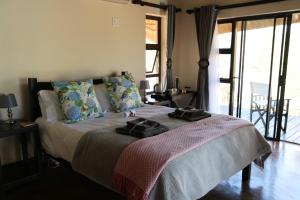 a bedroom with a bed with two towels on it at Lions Place in Grietjie Nature Reserve