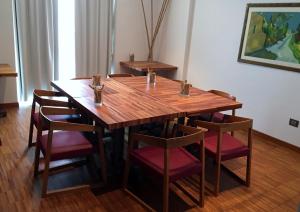 a wooden table with chairs around it in a room at Eureka Palace Hotel Spa Resort in Cassibile