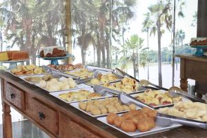 a buffet with many different types of pastries and desserts at Uchôa Teresina Hotel in Teresina