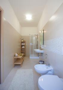 a white bathroom with a sink and a toilet at Casa Vistaverde in Perano