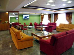 a lobby with couches and chairs and a table at Diana Hotel in Chios
