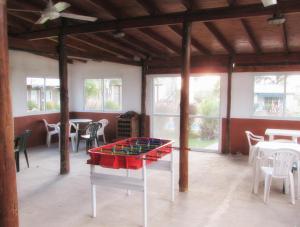 a ping pong table in a room with tables and chairs at Las Mentas in Victoria
