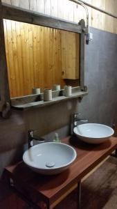 a bathroom with two white sinks and a mirror at Hochalmblick in Mallnitz