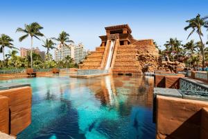 a large pool of water in front of a monument at The Royal at Atlantis in Nassau