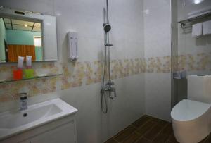 a bathroom with a shower and a toilet and a sink at And B&B in Hengchun