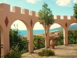 a view of the ocean from a building with arches at Villa Pappas in Kanali