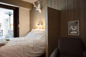 Rúm í herbergi á Little Suite Val d'Isère