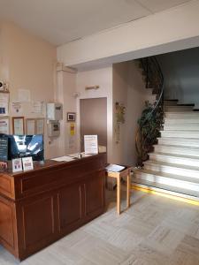 a store with a cash counter and a staircase at Hôtel-Restaurant Le Blueberry in Malaucène
