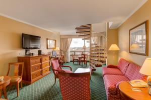 a hotel room with a couch and a spiral staircase at Barceló Guatemala City in Guatemala