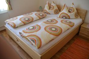 a bed with pillows on it in a bedroom at Pension Dürregger in Flattach