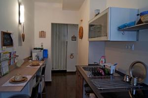 a kitchen with a sink and a counter top at Belvárosi Studio Apartman in Győr