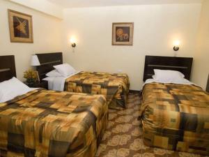 Ένα ή περισσότερα κρεβάτια σε δωμάτιο στο Hostal Samichay