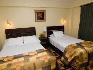 Ένα ή περισσότερα κρεβάτια σε δωμάτιο στο Hostal Samichay