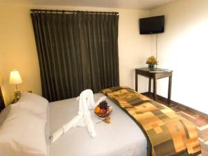 Ένα ή περισσότερα κρεβάτια σε δωμάτιο στο Hostal Samichay