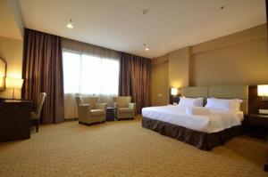 Ένα ή περισσότερα κρεβάτια σε δωμάτιο στο Lintas View Hotel