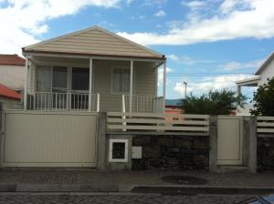 a house with a fence in front of it at A Casa Da Avenida in Madalena