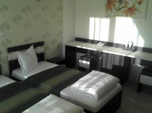 Postel nebo postele na pokoji v ubytování Best Hotel