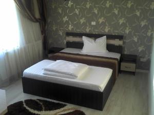 Postel nebo postele na pokoji v ubytování Best Hotel