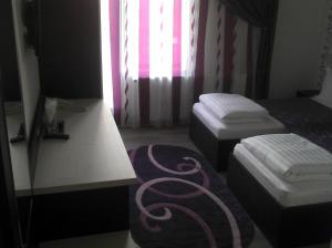 Postel nebo postele na pokoji v ubytování Best Hotel