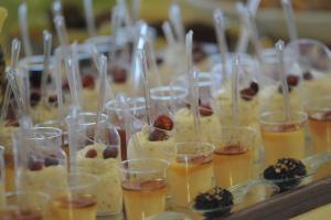 a bunch of desserts in cups on a table at Eureka Palace Hotel Spa Resort in Cassibile