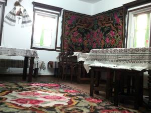 a living room with a piano and a rug at Casa Lia in Valea Putnei