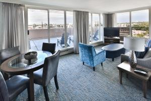 a hotel room with a living room with a view at Chateau Victoria Hotel & Suites in Victoria