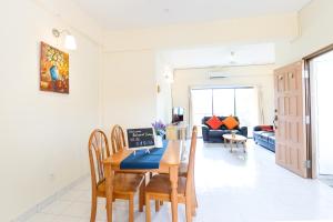 a dining room and living room with a table and chairs at Kijal Apartment in Kijal