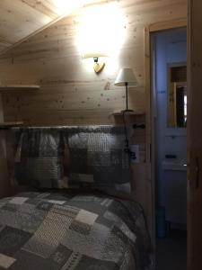 a bedroom with a bed in a wooden wall at Le petit Saint Bernard in Sainte-Foy-Tarentaise