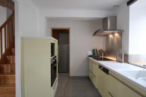 uma cozinha com um lavatório e uma bancada em Gite du lavoir em Le Puy-en-Velay