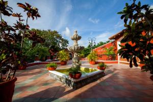 a fountain in the middle of a courtyard with plants at Occidental Cozumel - All Inclusive in Cozumel