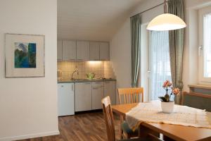 a kitchen and dining room with a table and a dining room at Haus Schweitzer - Naturns in Naturno +12 photos