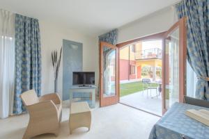 a living room with a sliding glass door to a patio at Villa Due Leoni - Residence in Brenzone sul Garda