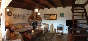 a living room with a couch and a fireplace at Casa Del Caminero En Tejeda in Tejeda