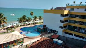 an aerial view of a resort with a swimming pool and the ocean at Tabatinga Residence Apart Hotel in Conde