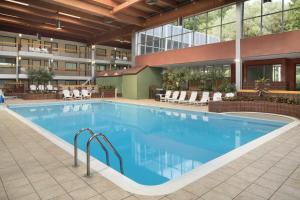 a large swimming pool in the courtyard of a hotel at Ramada by Wyndham Beaver Falls in Beaver Falls